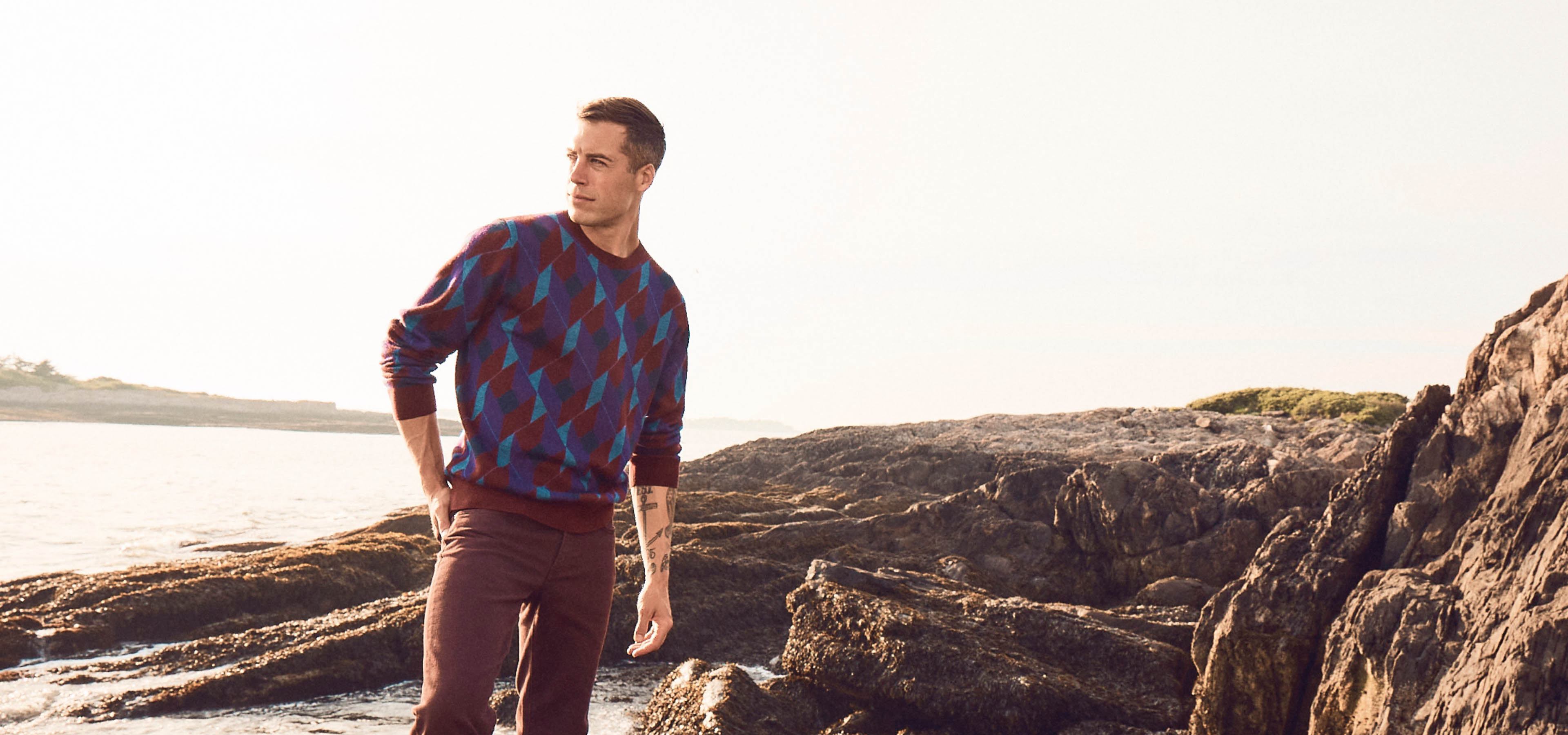 Brandon sewall on rocks by the water