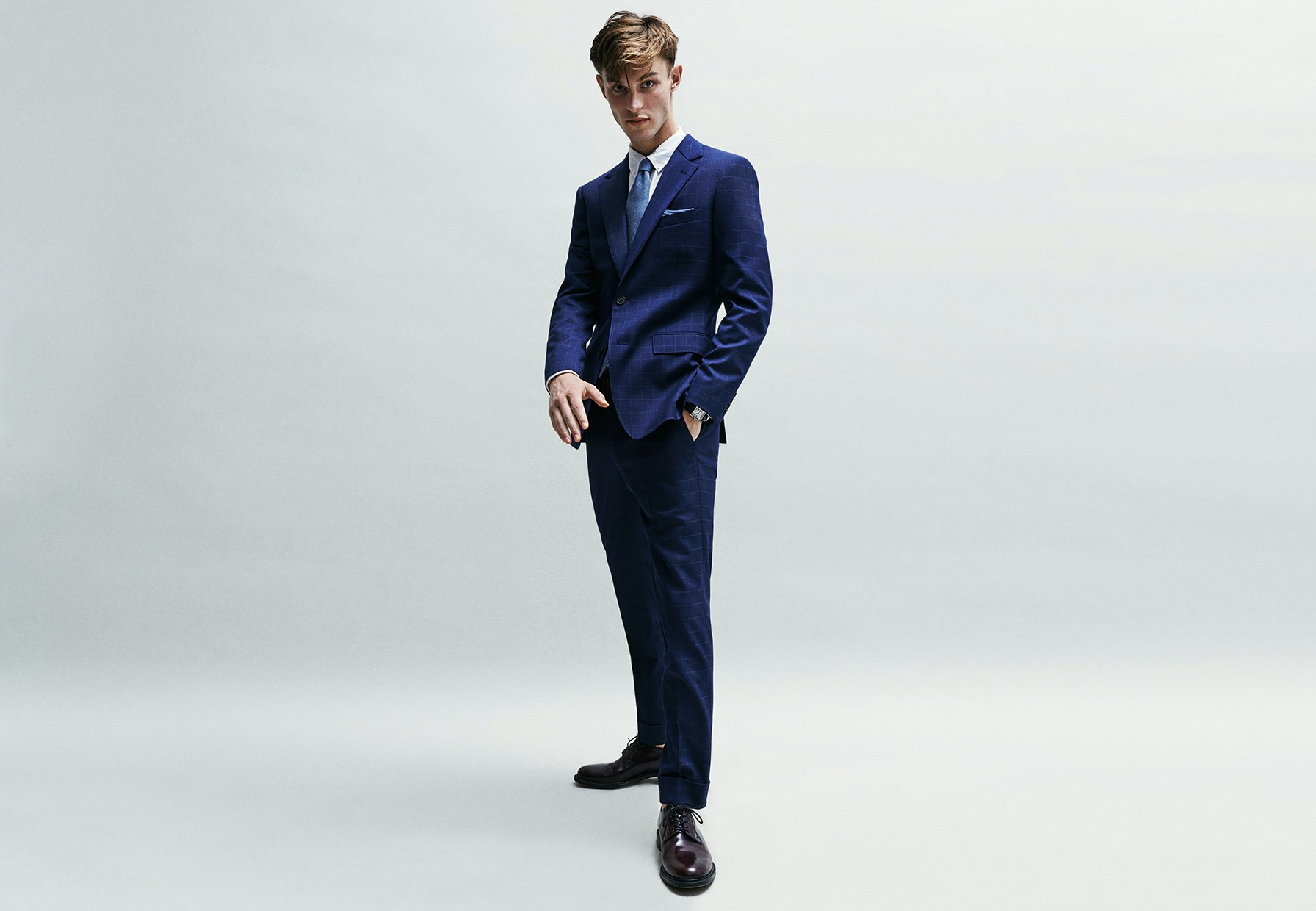The windowpane suit is a classic, but if you want a modern look, pair this comfy version with a poplin shirt, chambray tie, and linen pocket square. (Bonus tip: crop the pants, add a cuff.)
